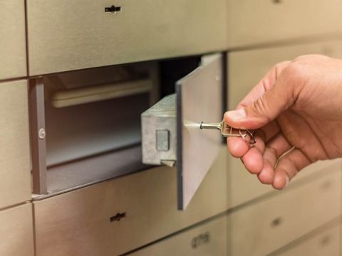 Hand opening a deposit box